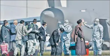  ?? PTI ?? Indian nationals being screened at the airbase after they were evacuated from coronaviru­s-hit Iran at Hindon airport on Tuesday.