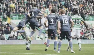  ??  ?? 2 Jozo Simunovic rises above the rest to fire in a header against Motherwell.