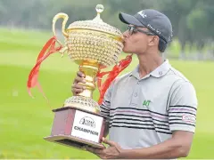  ?? AFP ?? Viraj Madappa kisses the Take Solutions Masters trophy.