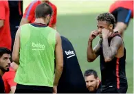  ?? AP ?? Barcelona’s Neymar (right) pretends to box teammate Pique during a training session. —