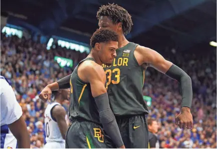  ?? JAY BIGGERSTAF­F/USA TODAY SPORTS ?? Baylor guard MaCio Teague, left, celebrates with forward Freddie Gillespie after scoring in a victory against Kansas last Saturday at Allen Fieldhouse.