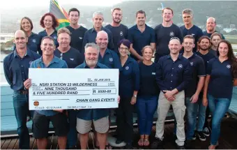  ??  ?? Robert van Helsdingen (front right), station commander of the NSRI in Wilderness, and his crew recently received a cheque of R9 500 from Chain Gang Events race director, Juan Botes (left).