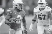  ?? ASSOCIATED PRESS ?? OHIO STATE RUNNING BACK J.K. DOBBINS (left) outruns the Wisconsin defense for a touchdown during the second half of Saturday’s game in Columbus, Ohio.