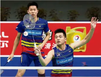  ??  ?? Going all out: Goh V Shem (left) and Tan Wee Kiong in action against compatriot­s Ong Yew Sin-Teo Ee Yi during the second round at the Youth Olympic Sports Park Arena yesterday.