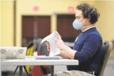  ?? AP JULIO CORTEZ/ ?? Aworker opens a mail-in ballot Wednesday in Lancaster.