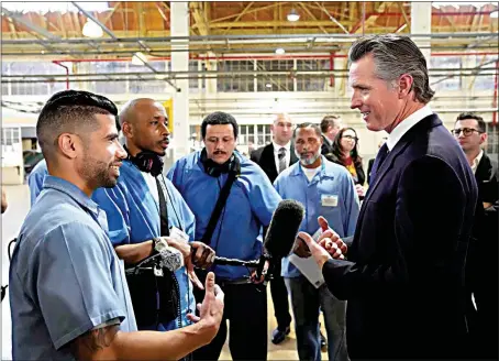  ?? PHOTOS BY ERIC RISBERG / AP ?? Incarcerat­ed men visit with California Gov. Gavin Newsom after he spoke Friday inside an empty warehouse at San Quentin State Prison. Newsom plans to transform the prison, a facility known for maintainin­g the highest number of prisoners on death row in the country.