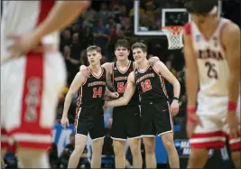  ?? JOSE LUIS VILLEGAS — THE ASSOCIATED PRESS ?? Princeton guard Matt Allocco (14), forward Zach Martini (54) and forward Caden Pierce (12) and teammates embrace in the final seconds of a 59-55 upset of Arizona in the NCAA Tournament in Sacramento on March 16.