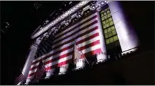  ?? PETER MORGAN — THE ASSOCIATED PRESS FILE ?? An American flag hangs on the front of the New York Stock Exchange, after the markets closed.