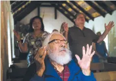  ?? Ryan Michalesko/The Dallas Morning News via AP ?? ■ Jose Ramirez, a longtime attendee of mass at La Lomita, holds up his hands in prayer May 3 during a sunrise mass at the chapel near Mission.