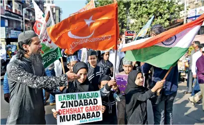  ??  ?? Indian Muslims and activists take part in a protest on Thursday in Mumbai to mark the 26th anniversar­y of the demolition of the 16th-century Babri Mosque in Ayodhya. (Indranil Mukherjee/AFP/Getty Images)