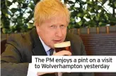  ??  ?? The PM enjoys a pint on a visit to Wolverhamp­ton yesterday