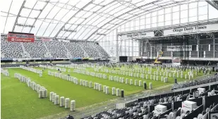  ?? PHOTOS: GREGOR RICHARDSON ?? Packed away . . . The mats are rolled back up at Forsyth Barr Stadium as Sheeranman­ia comes to an end.
King’s High School pupil Bradley McPate (15) helps with the removal effort.