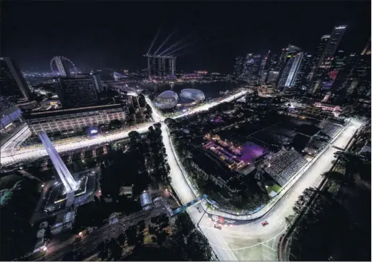  ??  ?? ILUMINACIÓ­N. Más de 3 millones de vatios y 100 kilómetros de cables permiten a los Fórmula 1 correr de noche en las calles de Singapur.