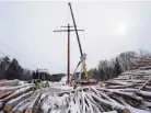  ?? ROBERT F. BUKATY/AP FILE ?? Workers connect a section of Maine’s controvers­ial hydropower transmissi­on corridor.