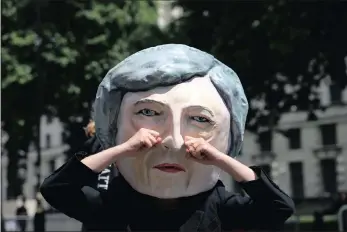  ?? PICTURE: REUTERS ?? A protester wears a Theresa May mask in London, yesterday.