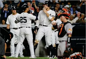 ?? AP PHOTO BY FRANK FRANKLIN II ?? New York Yankees’ Aaron Judge, center, and Gleyber Torres (25) celebrate after Torres’ three-run home run during the fifth inning of the second game of a baseball doublehead­er against the Baltimore Orioles, Monday, Aug. 12, 2019, in New York.