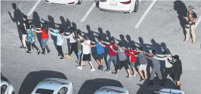  ?? Picture: JOE RAEDLE/GETTY ?? Students are brought out of the Marjory Stoneman Douglas High School after the shooting.