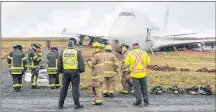  ?? CP PHOTO ?? A SkyLease Cargo plane skidded off a runway at Halifax Stanfield Internatio­nal Airport and stopped near a road early on Wednesday.