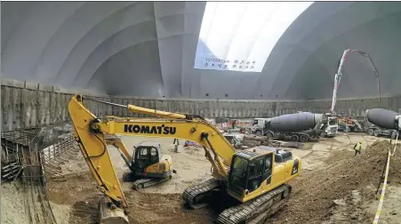  ?? LI XIN / XINHUA ?? A giant air-supported membrane structure covering an area of 4,240 square meters is erected at a constructi­on site in Beijing to prevent dust raised during constructi­on work from polluting the air.