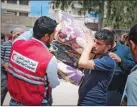  ??  ?? Qatar Red Crescent official distribute­s relief materials in Syria.