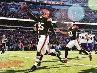  ?? Jason Miller / Getty Images ?? Myles Garrett of the Browns celebrates after recovering a fumble and taking it for a TD.