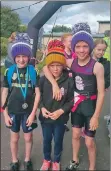  ??  ?? Triathlete­s who smiled while competing were presented with bobble hats.