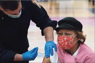  ?? Mark Lennihan / Associated Press ?? Lucy Gagliano, 75, is vaccinated on Feb. 10 at Central High School in Bridgeport.