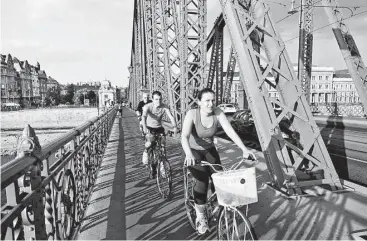  ?? Dominic Arizona Bonuccelli / Rick Steves’ Europe ?? Biking is an energizing way to take in the sights of Budapest, Hungary.