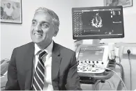  ?? AP Photo/Robert Stevens ?? ■ Dr. Sanjay Sharma, professor of cardiology at St. George’s University of London, speaks during an interview on Wednesday about a study he led that found which procedures can help identify athletes who are at risk for heart problems. He said the British soccer program will start re-checking players’ hearts at ages 18, 20 and 25.