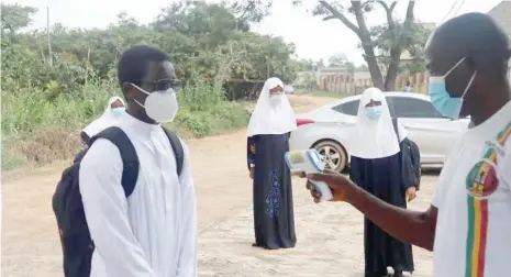  ?? Students of Voyage Internatio­nal school Abuja being checked by a teacher befre entering the school ??