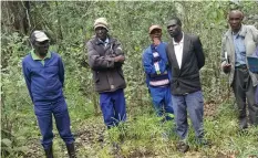  ??  ?? Headman Chieza (left) and other villagers inspect the reclaimed wetland. (Picture by Blessing Rwizi)