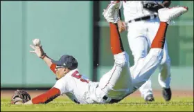  ?? Michael Dwyer The Associated Press ?? Red Sox right fielder Mookie Betts tries to field a ball hit by Kevin Kiermaier for an RBI single in the ninth inning of the Rays’ 9-2 win Saturday at Fenway Park. Boston won the doublehead­er’s second game 5-1.