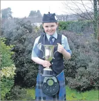  ?? 06_a12mamfpip­02 ?? Winner of the novice march Matthew MacKerral proudly shows off his trophy.