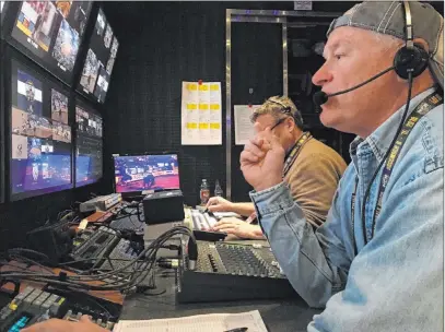  ?? Patrick Everson Las Vegas Review-journal ?? Rick Davidson, who directs the Wrangler National Finals Rodeo’s live satellite feed from a production trailer outside the Thomas & Mack Center, guides his camera crew through a series of shots during a Wrangler NFR go-around.