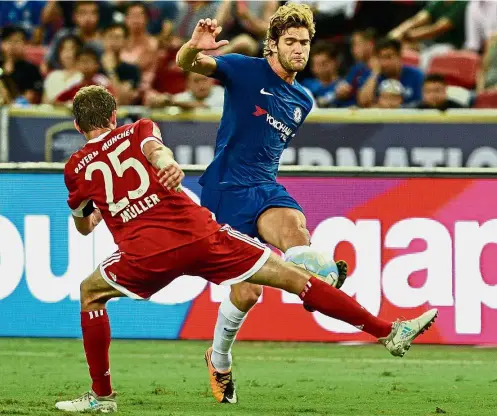  ??  ?? Chelsea’s Marcos Alonso sees his shot blocked by Bayern Munich’s Thomas Mueller. — AFP Striker’s intercepti­on: