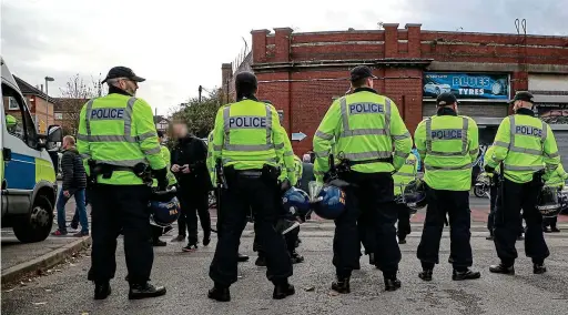  ?? ACTION PLUS/GETTY IMAGES ?? Taking no chances: police monitor fans at they arrive at St Andrew’s for the Birmingham derby