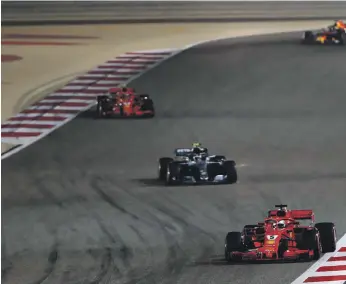  ?? Getty ?? Valtteri Bottas, sandwiched between the two red Ferraris at the Bahrain Grand Prix, was on fresher tyres than Sebastian Vettel, bottom right, but Bottas failed to make the advantage count