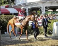  ?? HANS PENNINK — THE ASSOCIATED PRESS ?? Gun Runner, with Florent Feroux aboard, during the post parade before The Travers Stakes horse race at Saratoga Race Course in Saratoga Springs, Aug. 27, 2016. Gun Runner is the morning line favorite in The Grade 1 Whitney tonight.