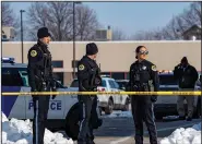  ?? (AP/The Des Moines Register/Zach Boyden-Holmes) ?? Law enforcemen­t officers stand outside a school housing an educationa­l program affiliated with the Des Moines, Iowa, school district following a shooting there Monday.