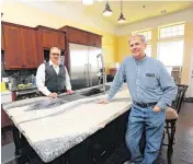  ?? [PHOTO BY PAUL HELLSTERN, THE OKLAHOMAN] ?? Daniel Keeslar of Insulated Concrete Forms & More and homeowner Kurt Swanson at the kitchen island, a single sheet of granite, at Swanson’s home in Meridian.