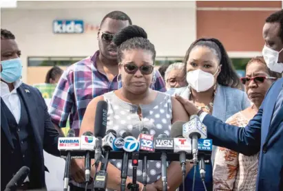  ?? ASHLEE REZIN GARCIA/SUN-TIMES ?? Flanked by family members, attorneys and supporters, Mia Wright cries during a press conference Thursday in the parking lot of the Brickyard Mall as she discusses a violent encounter with Chicago police officers.
