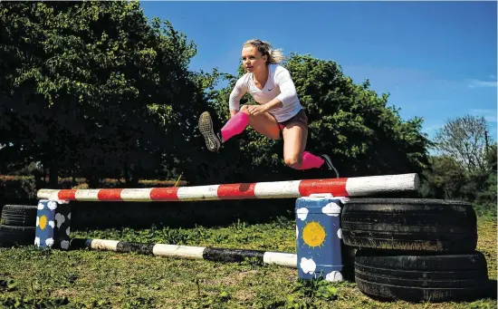  ?? HARRY MURPHY/SPORTSFILE ?? CHAMPION HURDLER: Molly Scott leaps over an improvised showjumpin­g fence while training for the high hurdles at her home in Hacketstow­n, Co Carlow – See full story P42