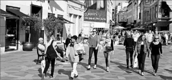  ?? — Photos by The Associated Press ?? Tourists stroll along the shopping street Stroeget in the centre of Copenhagen, Denmark.