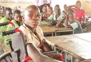  ??  ?? Special (in a wheelchair) . . . Another pupil at a school in Mbire district