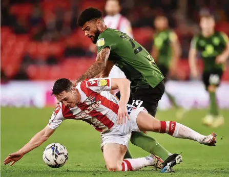  ?? ?? DOWN YOU GO: Stoke City midfielder Jordan Thompson is sent to the turf against Bournemout­h.