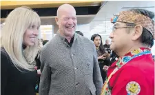  ??  ?? Shannon and Chip Wilson speak to Lekeyten, Kwantlen’s Elder in residence, at the opening of the Wilson School of Design.