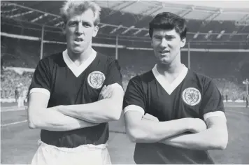  ??  ?? Ure and Jim Baxter stand with arms folded in front of a full house at Wembley