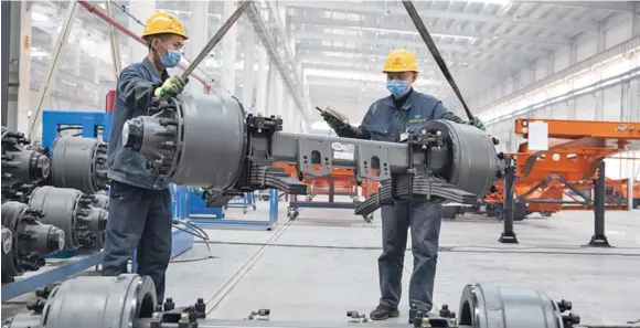  ?? Photo: Xinhua ?? People work at a workshop of a new energy vehicle enterprise at an industrial park in Jinzhong, north China’s Shanxi Province.