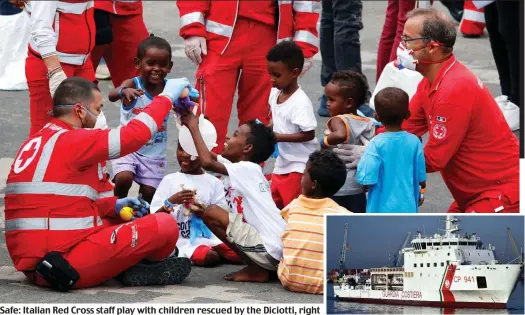  ??  ?? Safe: Italian Red Cross staff play with children rescued by the Diciotti, right