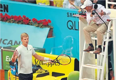  ??  ?? Kyle Edmund protests to the umpire after disruption by a spectator. Picture: Getty.